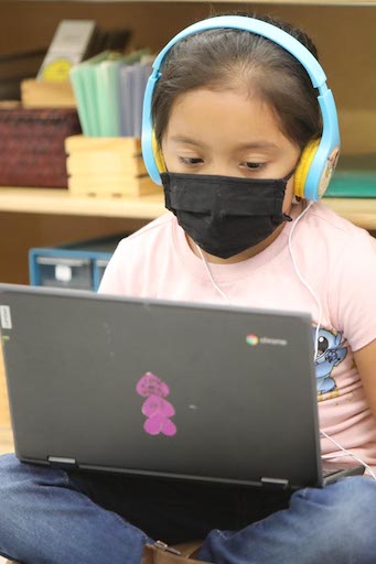Student on a laptop wearing headphones