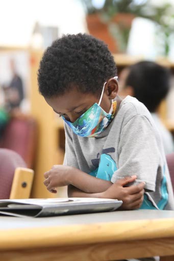 Student in class reading a book